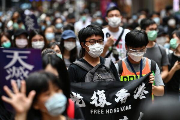 Protesters march on a road during a pro-democracy rally against a proposed new security law in Hong Kong on May 24, 2020. (Anthony Wallace/AFP via Getty Images)