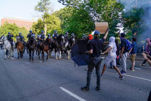 Police on horseback begin to approach demonstrators who had gathered to protest the death of George Floyd, near the White House in Washington on June 1, 2020. (AP Photo/Evan Vucci)