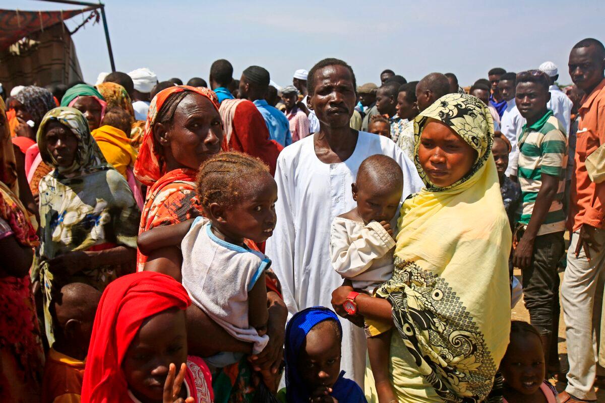 Displaced Sudanese queue to receive humanitarian aid supplies at the Kalma camp for internally displaced people in Darfur's state capital Niyala on Oct. 9, 2019. (Ashraf Shazly/AFP via Getty Images)