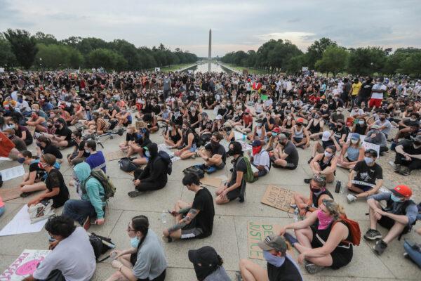 Demonstrators sit as they gather during a protest against the death in police custody of George Floyd, at the Lincoln Memorial in Washington, on June 4, 2020. (Reuters/Carlos Barria)