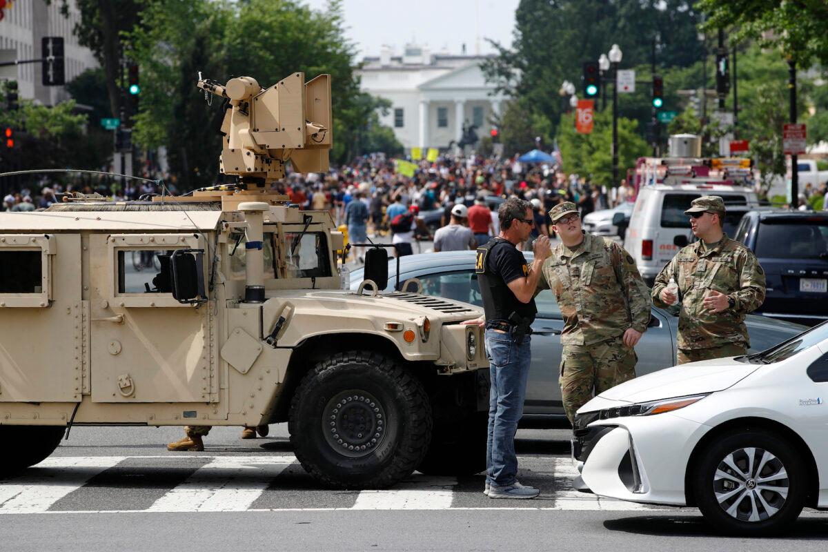 A checkpoint blocks traffic on 16th Street Northwest as people gather near the White House on June 6, 2020. (Patrick Semansky/AP Photo)