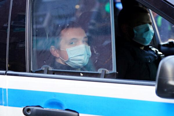 NYPD officers patrol in their vehicle while wearing protective masks during the CCP virus pandemic in New York City on May 7, 2020. (Cindy Ord/Getty Images)