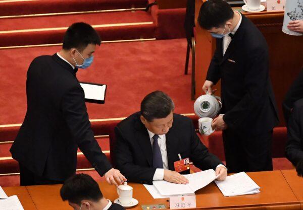 Attendants pour tea for Chinese leader Xi Jinping during the opening session of the rubber-stamp legislative conference at the Great Hall of the People in Beijing, China on May 22, 2020. (LEO RAMIREZ/AFP via Getty Images)