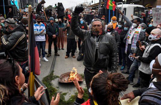 Aboriginal speakers talk to the crowds during a traditional smoking ceremony at the Black Lives Matter protest, Melbourne, Victoria, Australia, June 6, 2020. Australia. (William West / AFP via Getty Images)