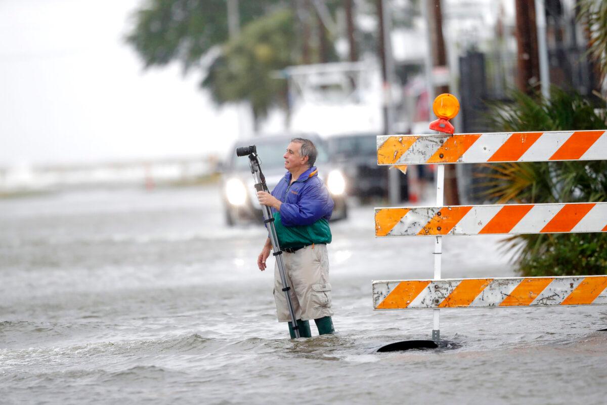 Charles Marsala, who lives in the Orleans Marina in the West End section of New Orleans, La., films a rising storm surge from Lake Pontchartrain, in advance of Tropical Storm Cristobal, on June 7, 2020. (Gerald Herbert/AP Photo)