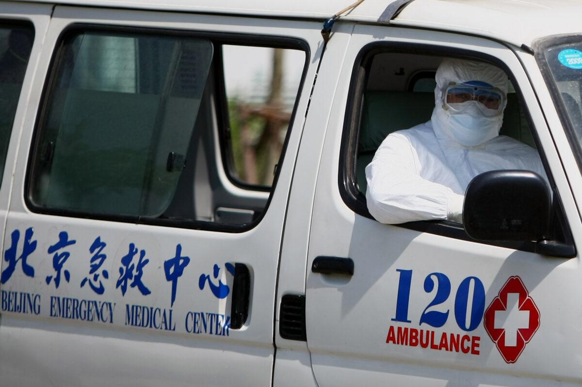 A hospital worker sits in the ambulance in Beijing's Ditan hospital in Beijing on May 17, 2009. (Feng Li/Getty Images)