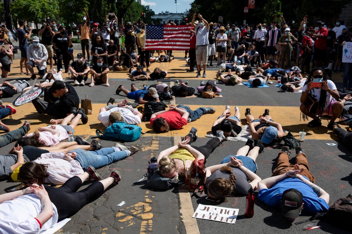 Protesters lie in the middle of the recently renamed Black Lives Matter Plaza near the White House during demonstrations over the death of George Floyd, in Washington on June 7, 2020. (Samuel Corum/Getty Images)