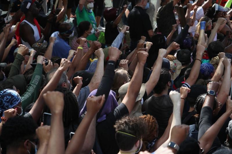 Protesters raise their hands in solidarity as they rally against the death in Minneapolis police custody of George Floyd, in downtown Houston, Texas, on June 2, 2020. (Adrees Latif/Reuters)