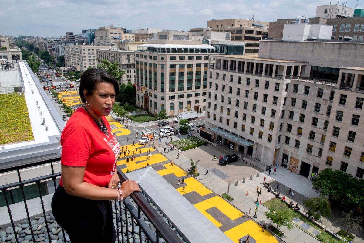 District of Columbia Mayor Muriel Bowser stands on the rooftop of the Hay Adams Hotel near the White House and looks out at the words "Black Lives Matter" that have been painted in bright yellow letters on the street by city workers and activists in Washington on June 5, 2020. (Executive Office of the Mayor/Khalid Naji-Allah via AP)