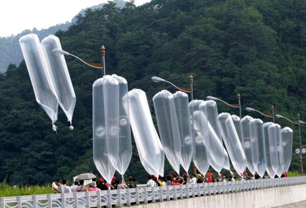 South Korean conservative activists launch balloons carrying leaflets denouncing North Korean leader Kim Jong Il during a rally in Hwacheon, South Korea, on July 29, 2010. (Ahn Young-joon/AP)