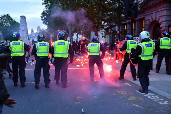 Flares are thrown in the direction of police amid clashes with demonstrators in London, UK, on June 7, 2020. (Dylan Martinez/Reuters)