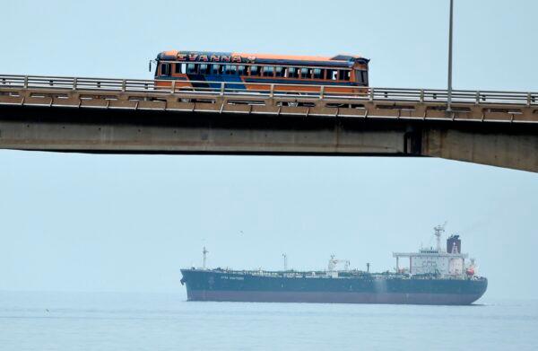 A bus drives over the General Rafael Urdaneta bridge as an oil tanker sails the Maracaibo lake in Maracaibo, Venezuela, on March 15, 2019. (Juan Barreto/AFP/Getty Images)