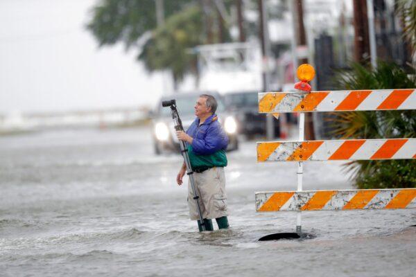 Charles Marsala, who lives in the Orleans Marina in the West End section of New Orleans, films a rising storm surge from Lake Pontchartrain, in advance of Tropical Storm Cristobal, La., on June 7, 2020. (Gerald Herbert/AP Photo)