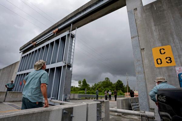 Crews from the Southeast Louisiana Flood Protection Authority East close the Bayou Road flood gate in St. Bernard Parish, ahead of Tropical Storm Cristobal, La., on June 6, 2020. (Max Becherer/The Times-Picayune/The New Orleans Advocate)