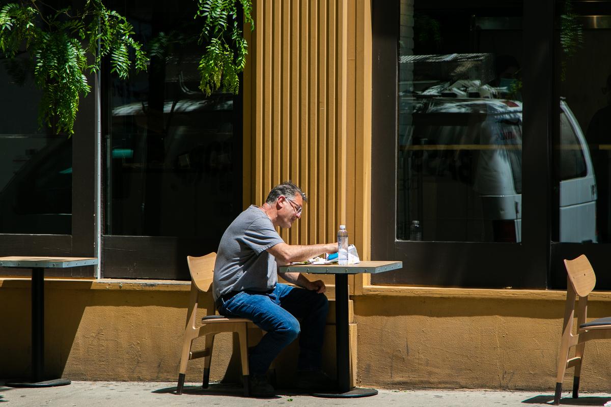A man eats a meal outside a restaurant in Manhattan, New York ,on June 9, 2020. (Chung I Ho/The Epoch Times)
