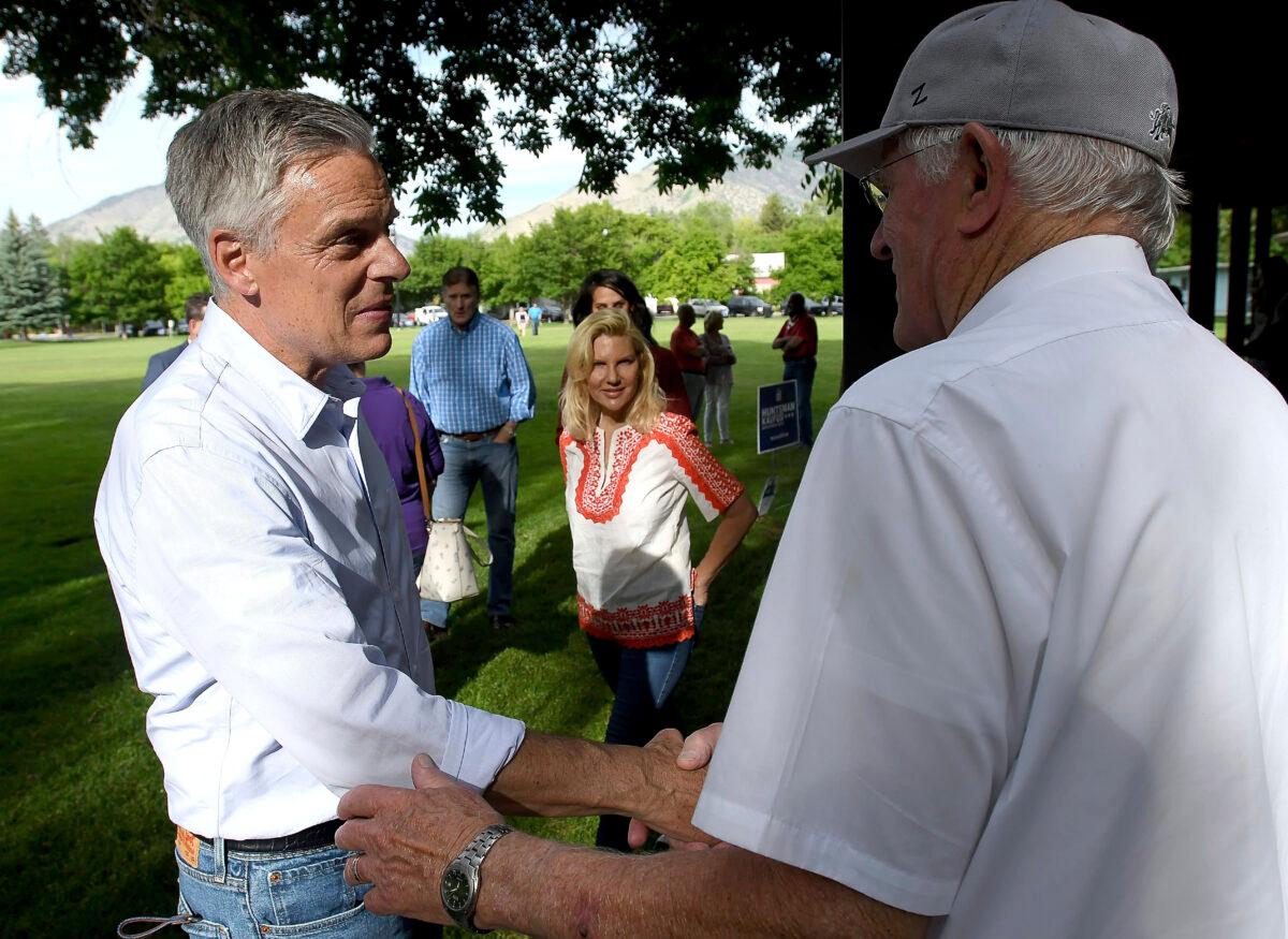 Utah gubernatorial candidate Jon Huntsman Jr. (left), shakes hands with people during a campaign stop in Logan, Utah, on June 4, 2020. (Eli Lucero/Herald Journal via AP)