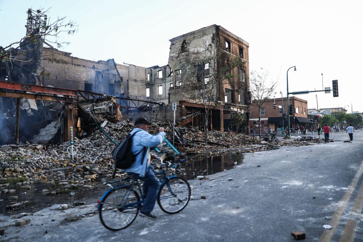 A destroyed building smolders near the Minneapolis Police Department's 3rd Precinct the day after it was attacked and burned by rioters following the death of George Floyd, in Minneapolis, Minn., on May 29, 2020. (Charlotte Cuthbertson/The Epoch Times)