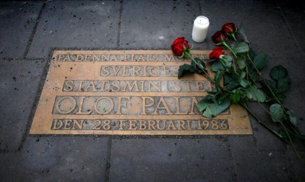 Roses are laid on a plaque marking the location where Swedish Prime Minister Olof Palme was shot and killed 25 years ago on a street in Stockholm on Feb. 28, 2011. (Bob Strong/Reuters)