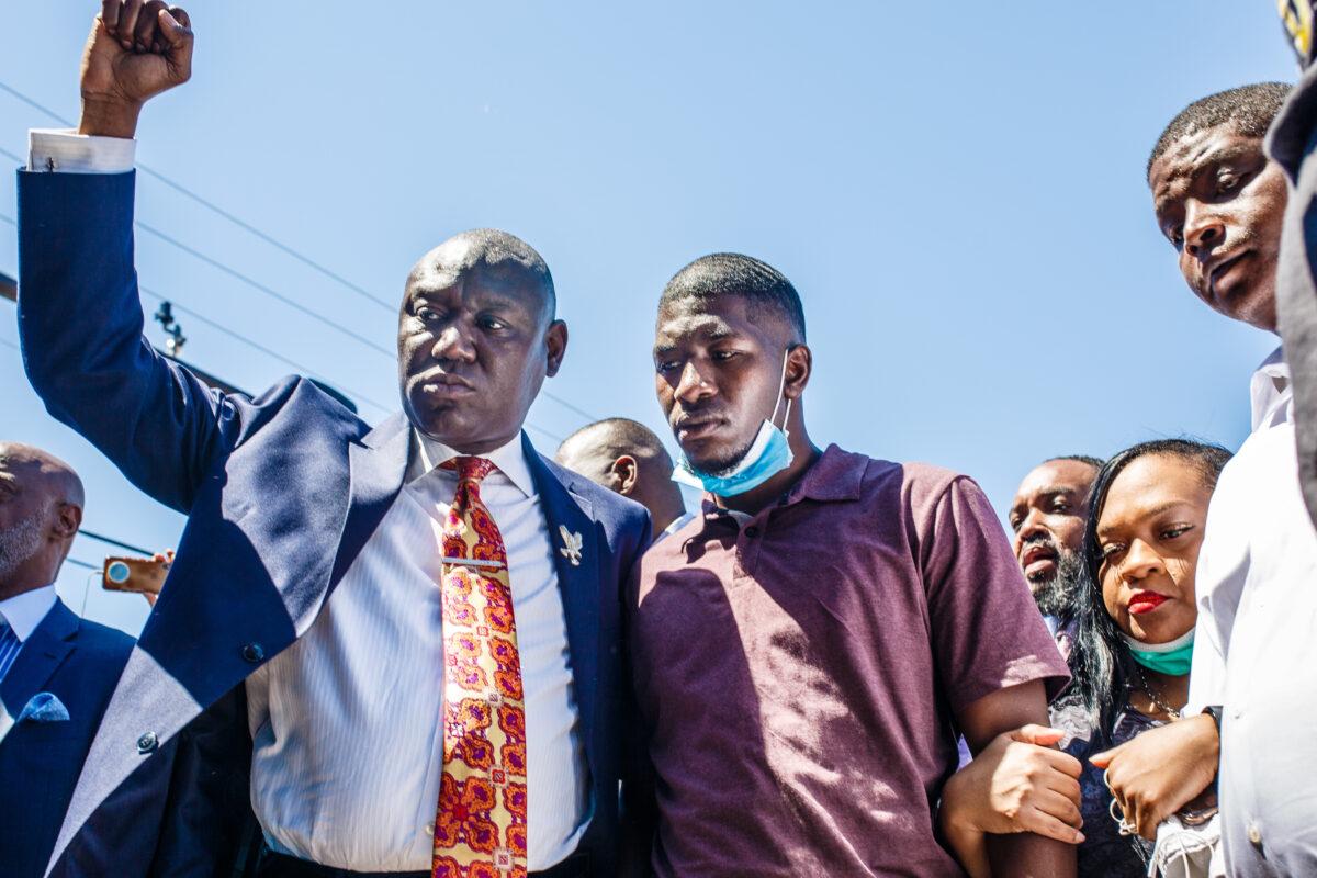 George Floyd's son, Quincy Mason Floyd (second from left) and family attorney Ben Crump (L) and other family members visit the site where George Floyd died in Minneapolis, Minn., on June 3, 2020.  (Kerem Yucel/AFP via Getty Images)
