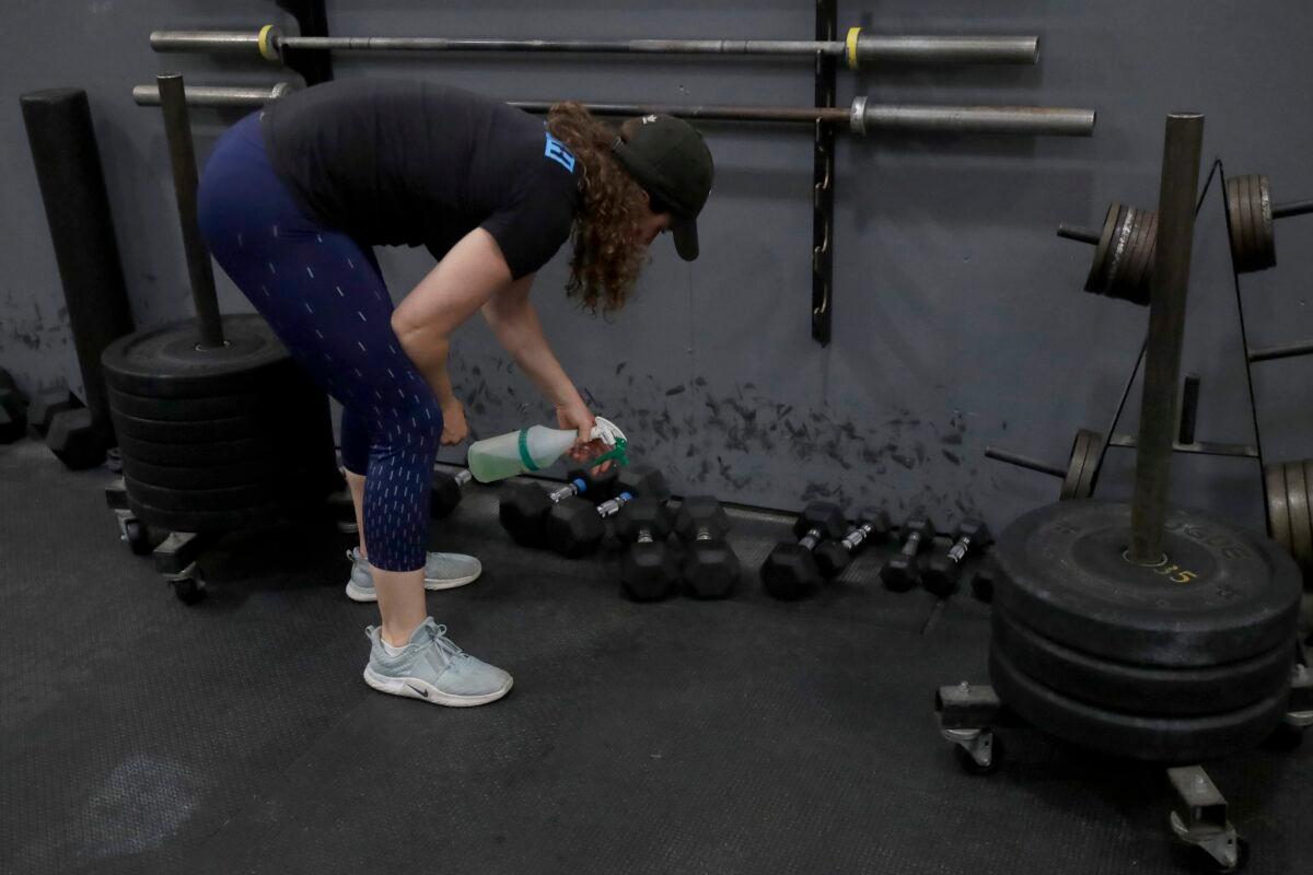 A Crossfit coach leans off weight training equipment in a CrossFit in San Francisco, Calif. in an April 24, 2020, file photograph. (Jeff Chiu/AP Photo)