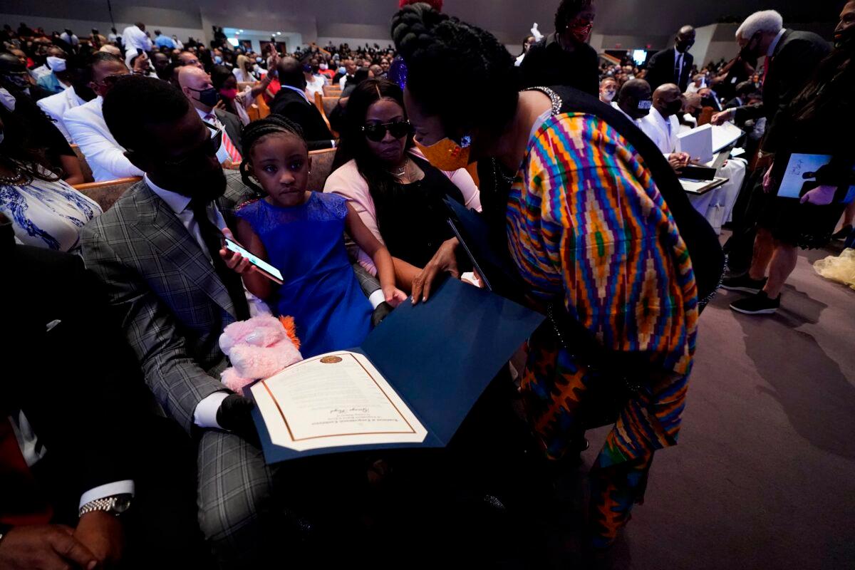 Rep. Shiela Jackson Lee (D-Texas), right, speaks with Roxie Washington, Gianna Floyd, and former NBA player Stephen Jackson during the funeral service for George Floyd at The Fountain of Praise church in Houston, Texas on June 9, 2020. (David J. Phillip/AFP/Getty Images)
