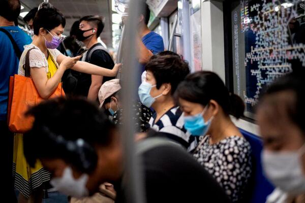 People wearing masks travel on a subway train during morning rush hour in Beijing on June 8, 2020. (Noel Celis/AFP via Getty Images)
