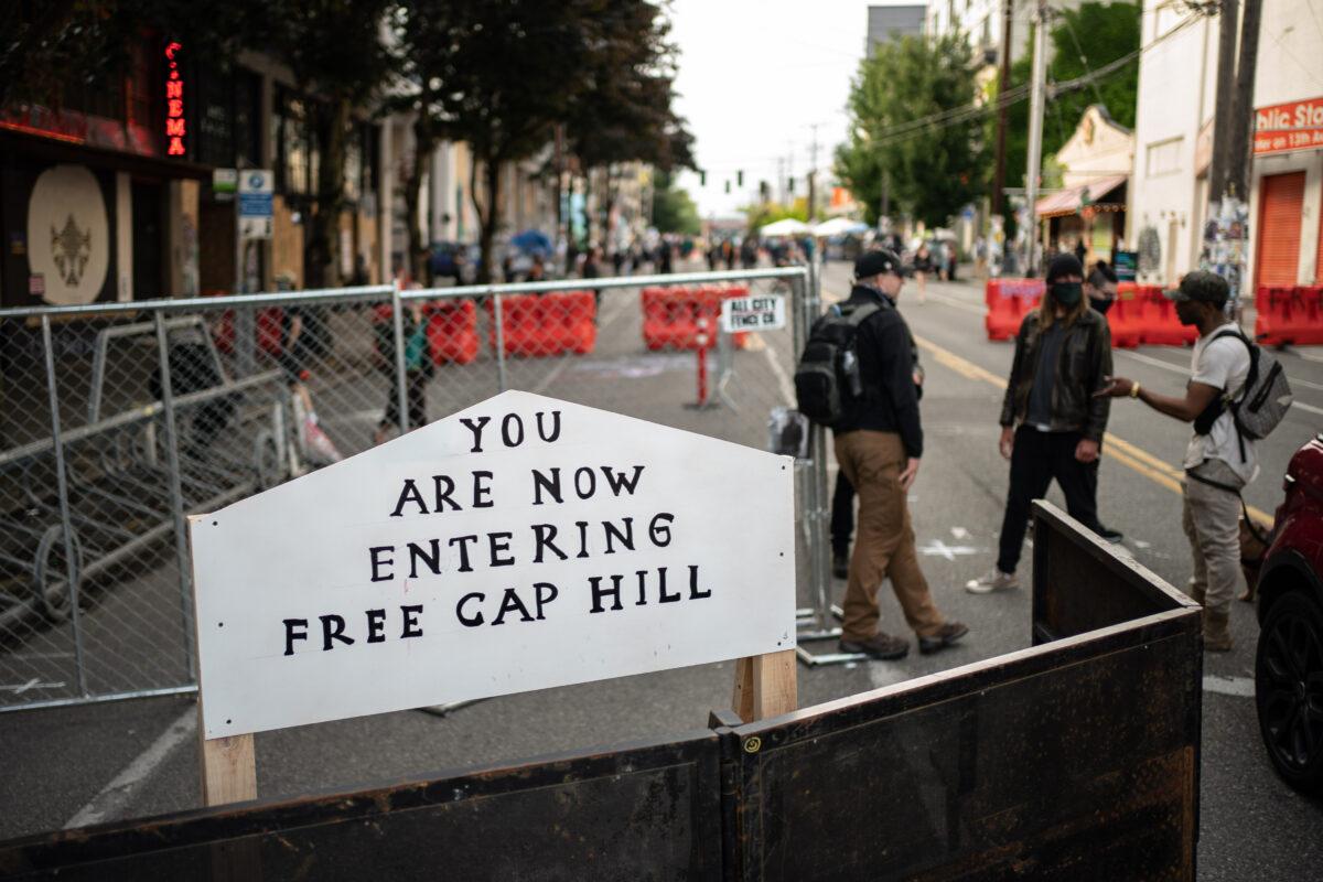 A sign is seen on a barrier at an entrance to the so-called "Capitol Hill Autonomous Zone,” in Seattle, Wash., on June 10, 2020. (David Ryder/Getty Images)