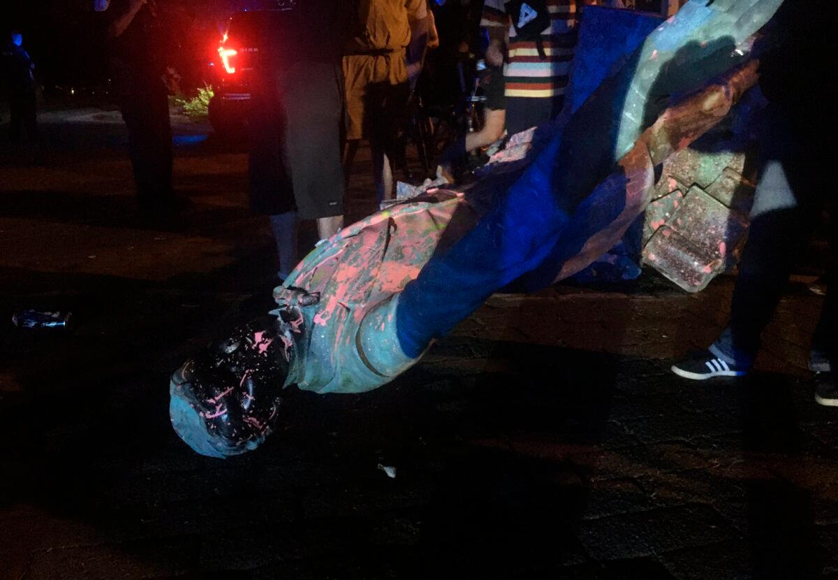 The statue of Confederate President Jefferson Davis is splattered with paint after it was toppled Wednesday night, along Monument Drive in Richmond, Va., on June 10, 2020. (Dylan Garner/Richmond Times-Dispatch via AP)