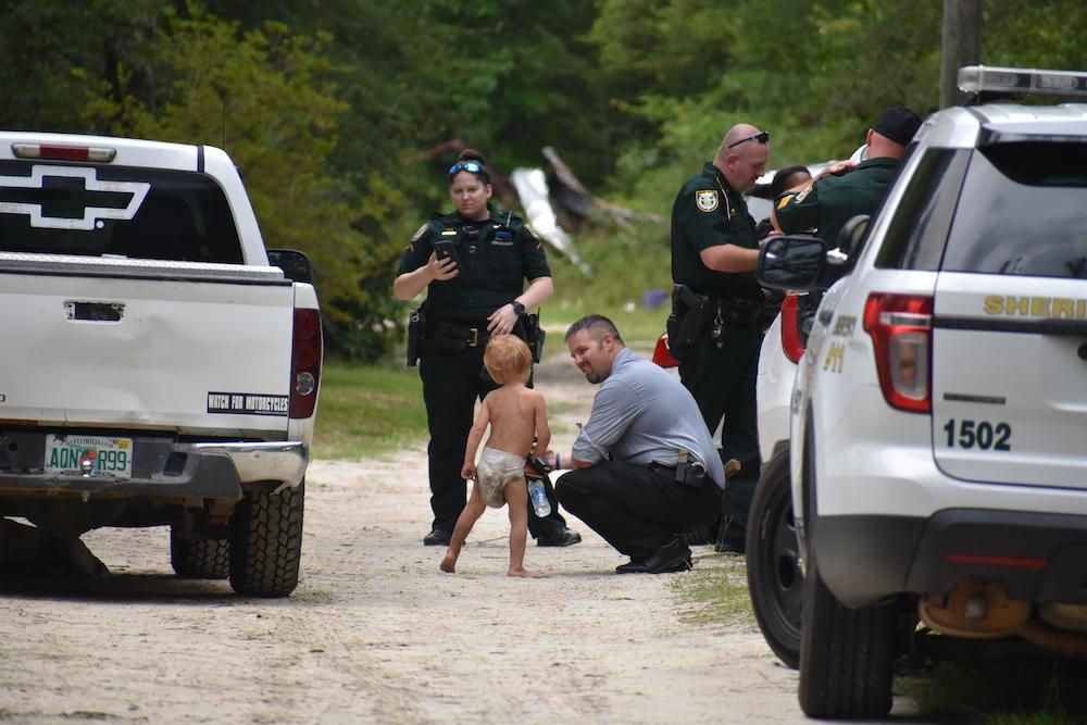 Three-year-old Marshal Butler with deputies after he was found. (Courtesy of <a href="https://waltonso.org/">Walton County Sheriff's Office</a>)