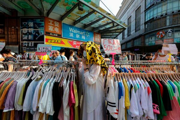 Street vendors are selling clothes at an outdoor market set up in a street in Wuhan, China on June 8, 2020. (STR/AFP via Getty Images)