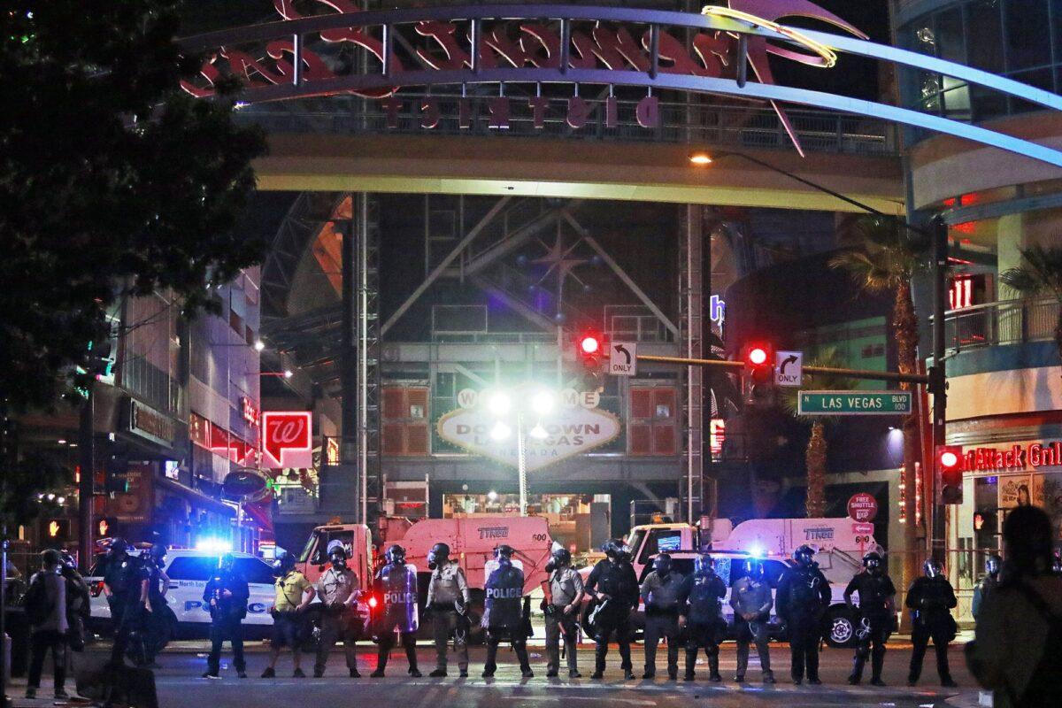 Police stand in formation at the entrance to Fremont Street Experience in downtown Las Vegas, on June 1, 2020. (Ronda Churchill/AP Photo)