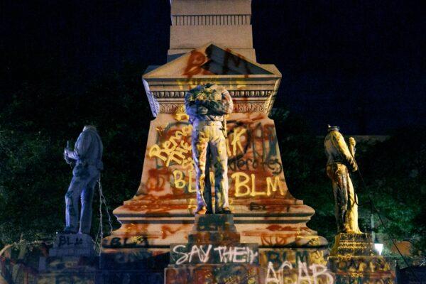 The statues on the Confederate monument are covered in graffiti and beheaded after a protest in Portsmouth, Va., on June 10, 2020. (Kristen Zeis/The Virginian-Pilot/AP)