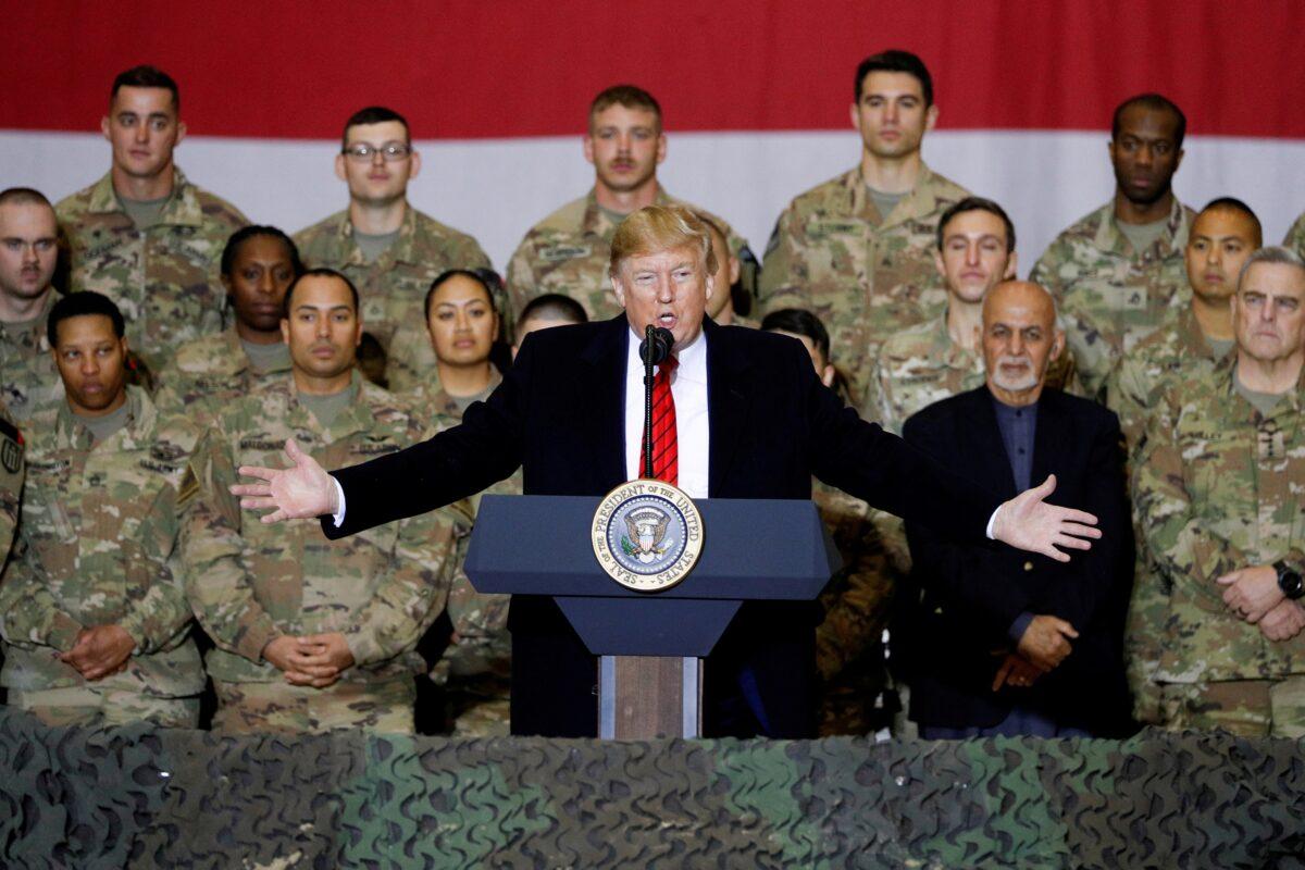 President Donald Trump delivers remarks to U.S. troops, with Afghanistan President Ashraf Ghani standing behind him, during an unannounced visit to Bagram Air Base, Afghanistan, Nov. 28, 2019. (Tom Brenner/Reuters)
