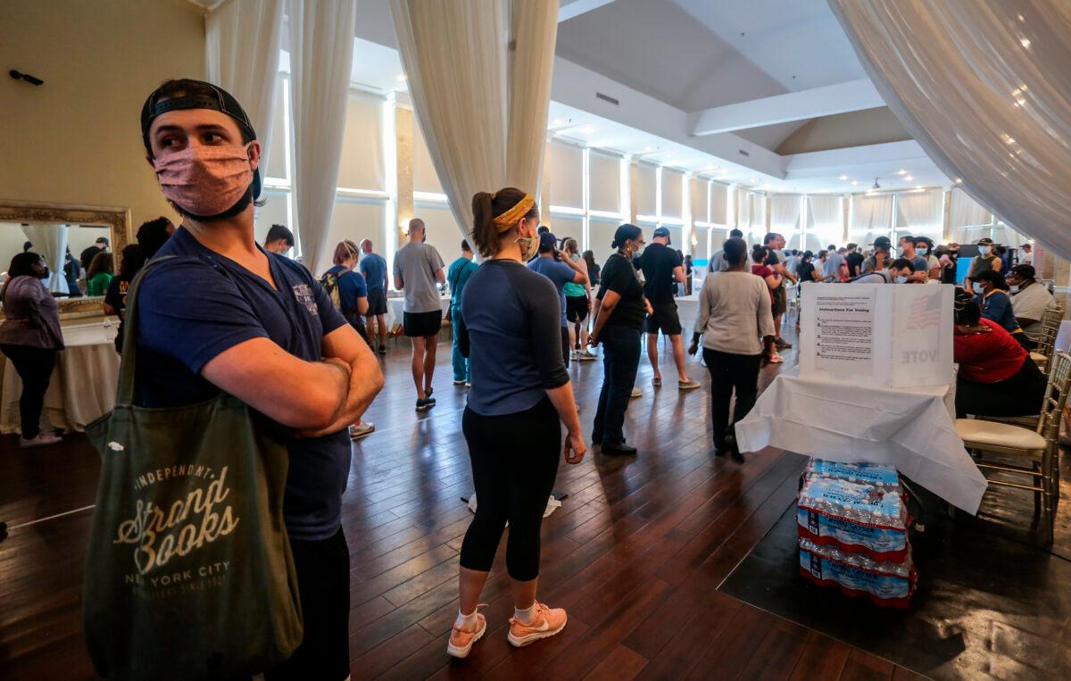 Voters wait in line to cast their ballots in the state's primary election at a polling place on June 9, 2020. (Ron Harris/AP Photo)