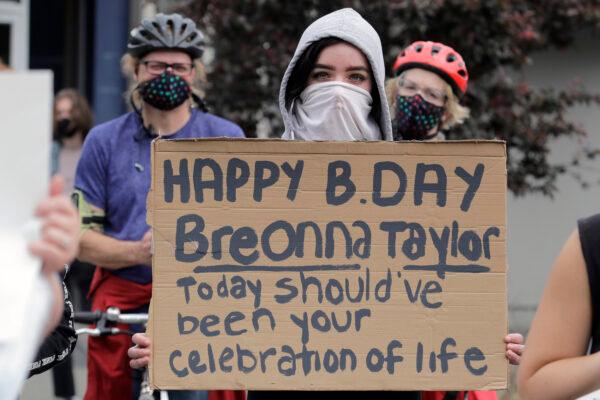 A person holds a sign that mentions Breonna Taylor during a protest in Tacoma, Wash., on June 5, 2020. (AP Photo/Ted S. Warren)