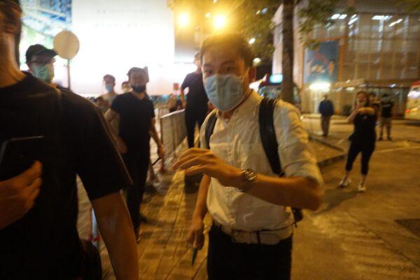 A man threatens an Epoch Times staffer and other citizens with his knife in Hong Kong, on June 12, 2020. (Jerry/The Epoch Times)