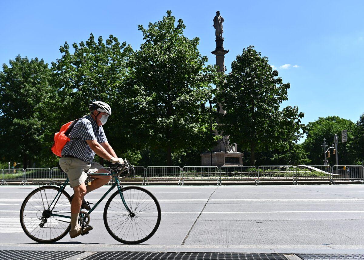 A cyclist bikes around Columbus Circle in New York, N.Y., June 12, 2020. (Angela Weiss/AFP via Getty Images)