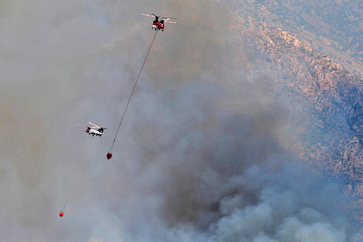 Wildfire air attack crews continue to battle the Bighorn Fire along the western side of the Santa Catalina Mountains, in Oro Valley, Ariz., on June 12, 2020. (Matt York/AP Photo)