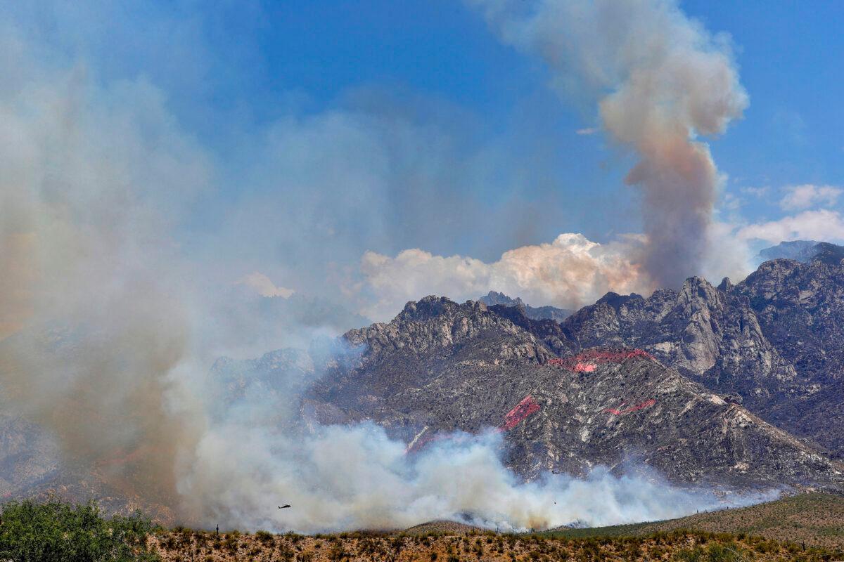 Wildfire air attack crews continue to battle the Bighorn Fire along the western side of the Santa Catalina Mountains, in Oro Valley, Ariz., on June 12, 2020. (Matt York/(AP Photo)