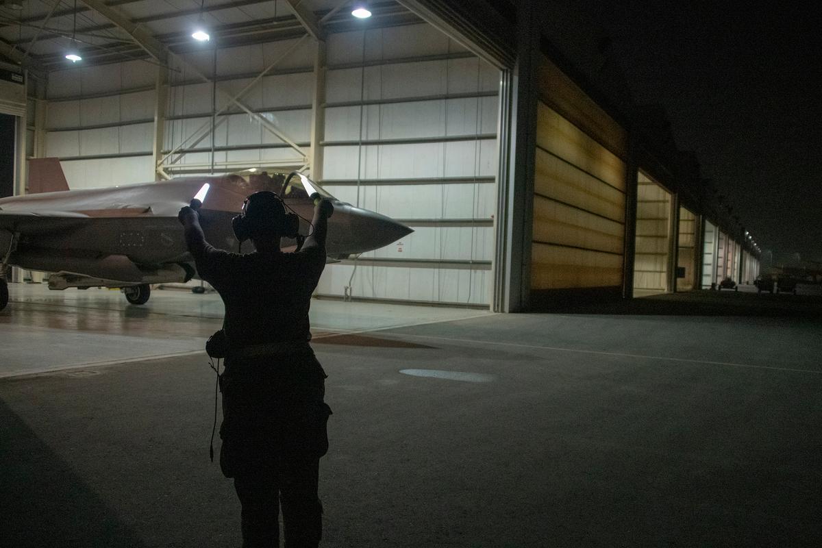 U.S. Air Force Capt. Emily Thompson launches an F-35A Lightning II while Airman 1st Class Ashlin Randolph, a 380th Aircraft Maintenance Squadron weapons load crew member, gives the signal to proceed recently at Al Dhafra Air Base, United Arab Emirates. (<a href="https://www.dvidshub.net/image/6235476/first-female-fighter-pilot-conduct-f-35-combat-mission">Tech. Sgt. Kat Justen</a>/U.S. Air Force)