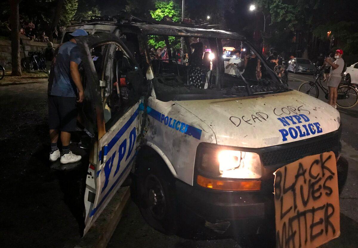 The remains of a scorched police vehicle lie vandalized during riots in the Fort Greene neighborhood in the Brooklyn borough of New York on May 29, 2020. (Thomas Urbain/AFP via Getty Images)