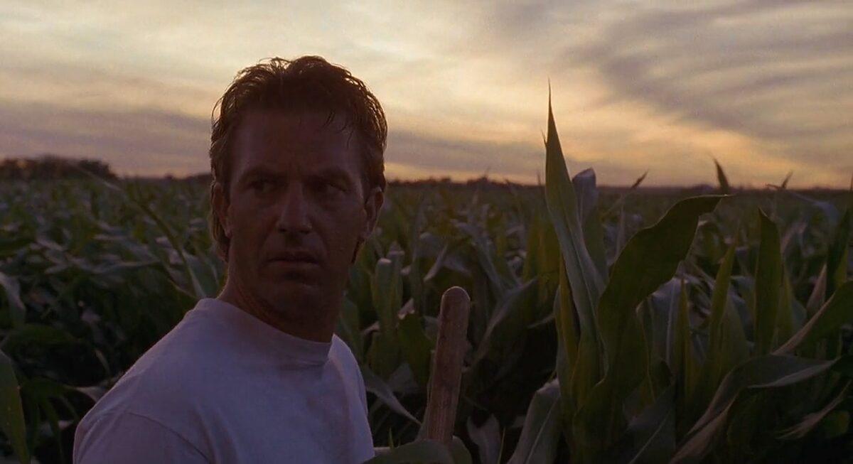 Ray Kinsella (Kevin Costner) listening to the disembodied voice (Ed Harris) in his cornfield, in "Field of Dreams." (Universal Pictures)