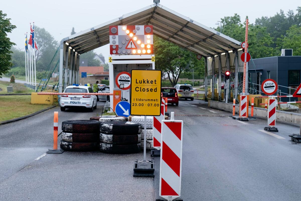 A sign with the opening hours of the border checkpoint between Harrislee in Germany and Padborg in Denmark is displayed in front the border crossing in Harrislee, Germany, June 13, 2020. (Frank Molter/dpa via AP)