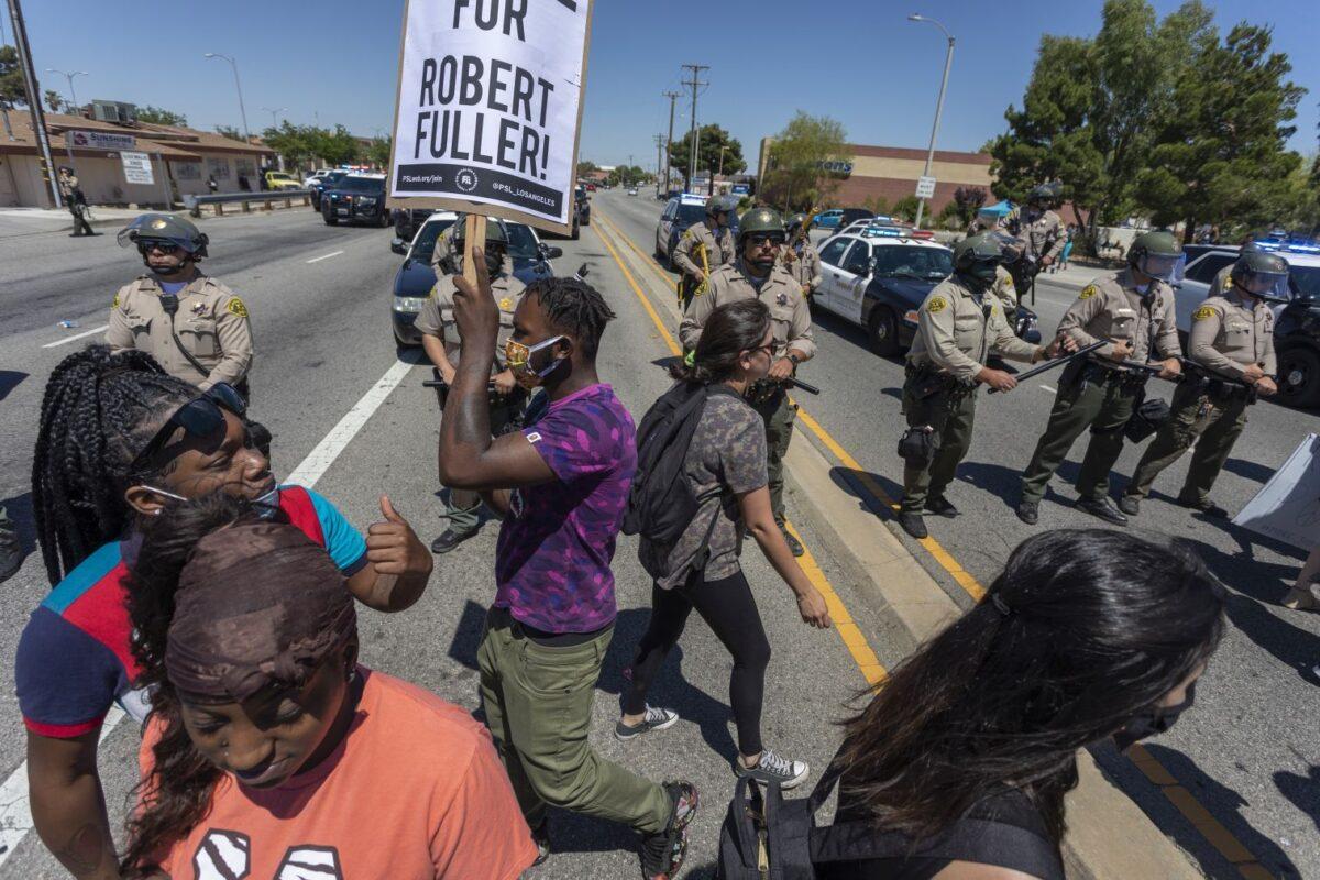 Sheriffs block marchers from continuing down E. Palmdale Boulevard after a demonstration in Palmdale, Calif., on June 13, 2020. (David McNew/Getty Images)
