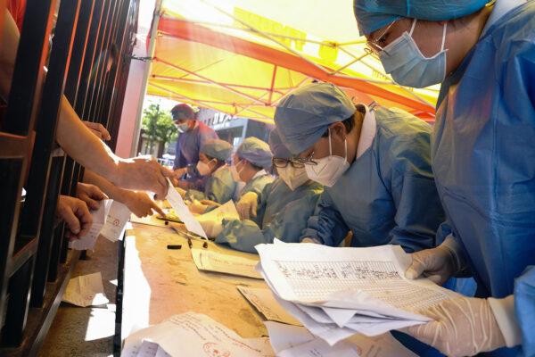 Medical workers sort COVID-19 nucleic acid test results for the citizens at a hospital in Beijing, China on June 14, 2020. (Lintao Zhang/Getty Images)
