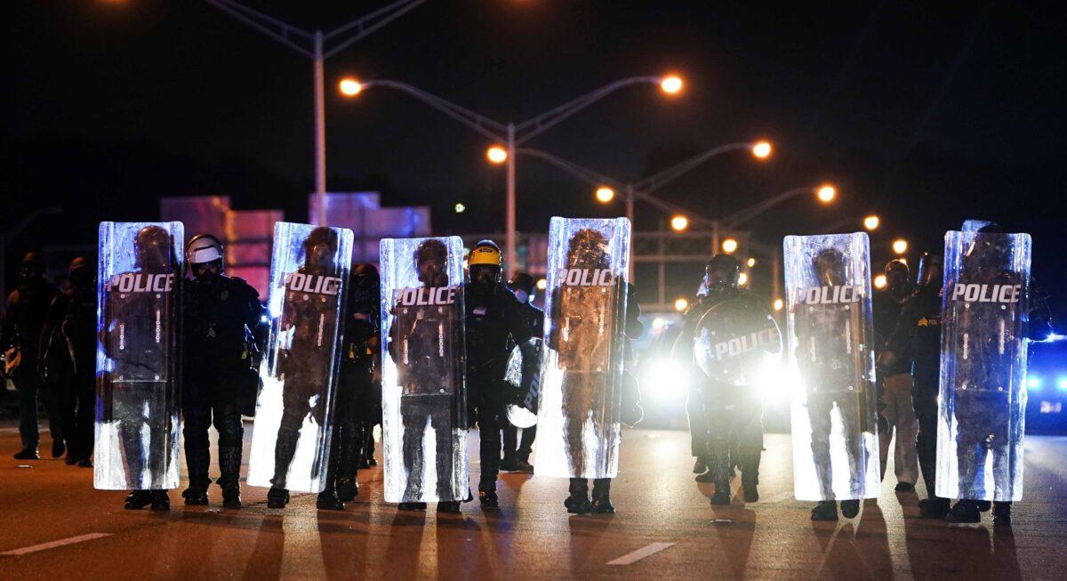 Police with riot shields advance to detain protesters for blocking traffic on a freeway during a protest over the police shooting death of Rayshard Brooks, in Atlanta, Georgia, on June 13, 2020. (Elijah Nouvelage/Reuters)