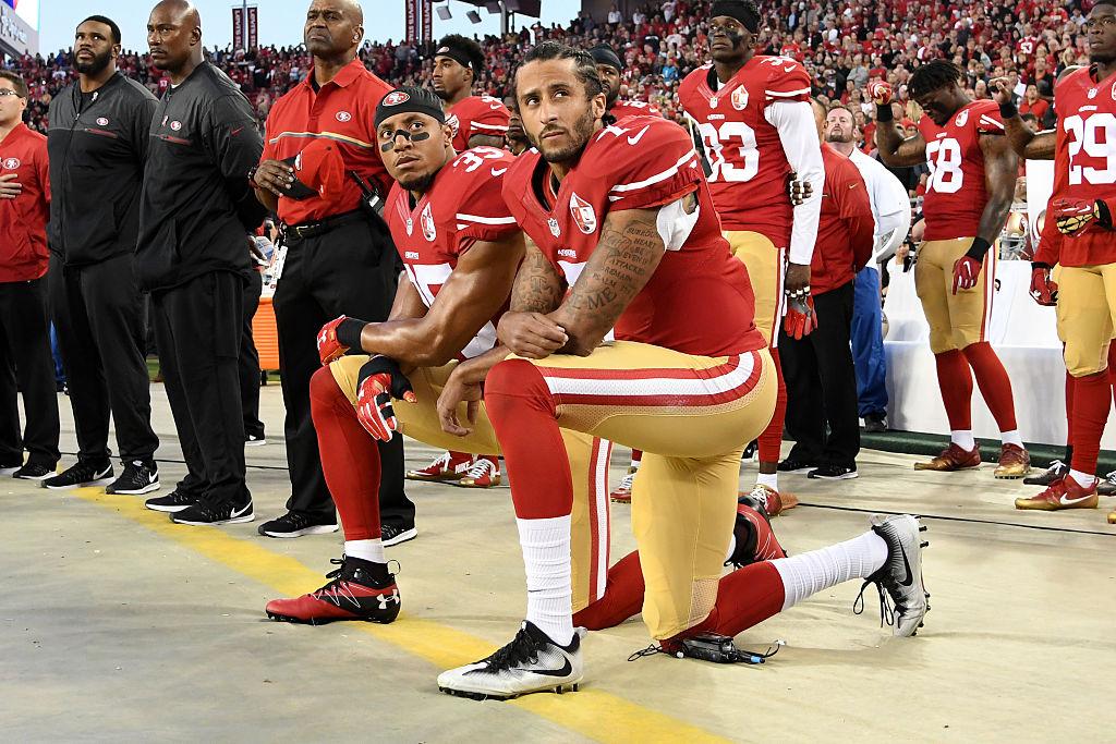 Kaepernick, #7, and Eric Reid, #35 of the San Francisco 49ers, kneel in protest during the national anthem at Levi's Stadium in Santa Clara, California, on Sept. 12, 2016 (Thearon W. Henderson/Getty Images)