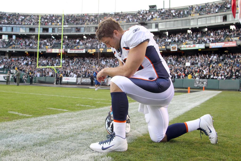 Tebow, formerly #15 of the Denver Broncos, prays before their game against the Oakland Raiders at Oakland Coliseum in Oakland, California, on Nov. 6, 2011. (Ezra Shaw/Getty Images)