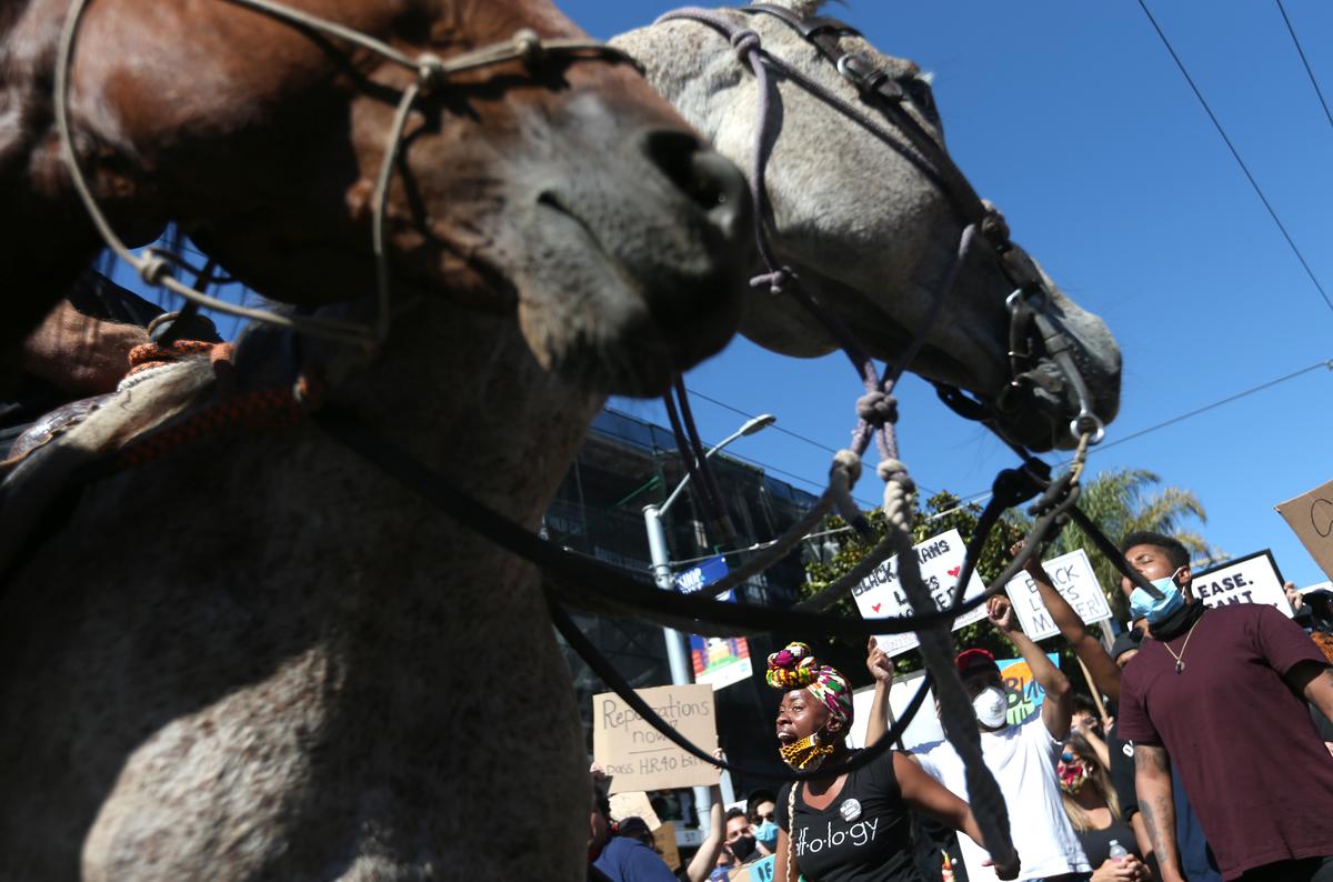 Protesters chant next to horses during a demonstration in George Floyd's name in San Francisco, California, on June 3, 2020 (Justin Sullivan/Getty Images)
