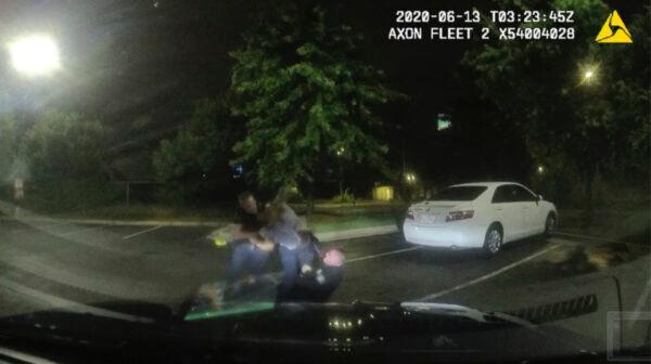 Rayshard Brooks (C) struggling with officers Garrett Rolfe (L) and Devin Brosnan in the parking lot of a Wendy's restaurant, in Atlanta, Ga., on June 13, 2020. (Atlanta Police Department via AP)